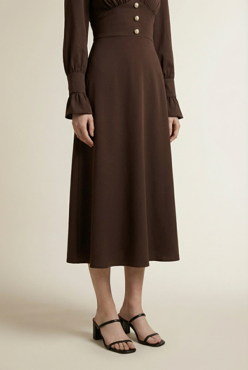 Close-up of the model's lower body wearing CAMILLE | Robe longue élégante a détails patchwork