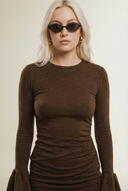 Close-up of the model wearing ADÈLE | Robe pres du corps a manches évasées