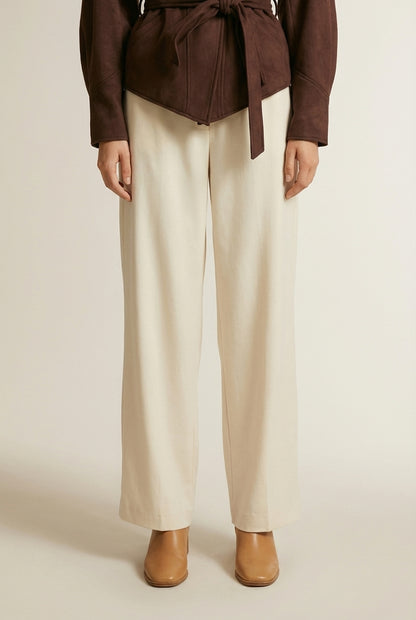 Close-up of the model's lower body wearing ELINE | Veste femme à épaules plissées et ceinture nouée